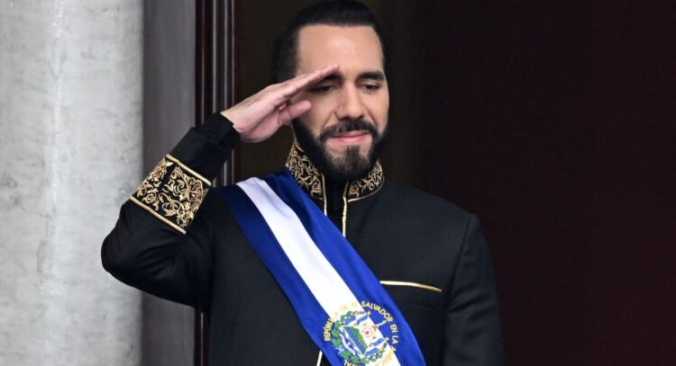 (FILES) El Salvador's President Nayib Bukele salutes during the military parade after being sworn in at the National Palace in downtown San Salvador on June 1, 2024. El Salvador's ruling-party-dominated Congress is discussing indefinite presidential reelection on July 31, 2025, aiming towards President Nayib Bukele's continued presidency. This reform also proposes extending the term of office from five to six years. (Photo by Marvin Recinos / AFP)